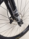 Action shot of the Specialized Status 160 navigating rough terrain, demonstrating durability and control.