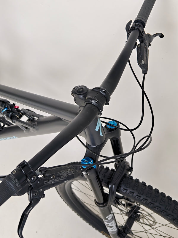 A beautifully composed shot of the Specialized Status 160 against a backdrop of nature.