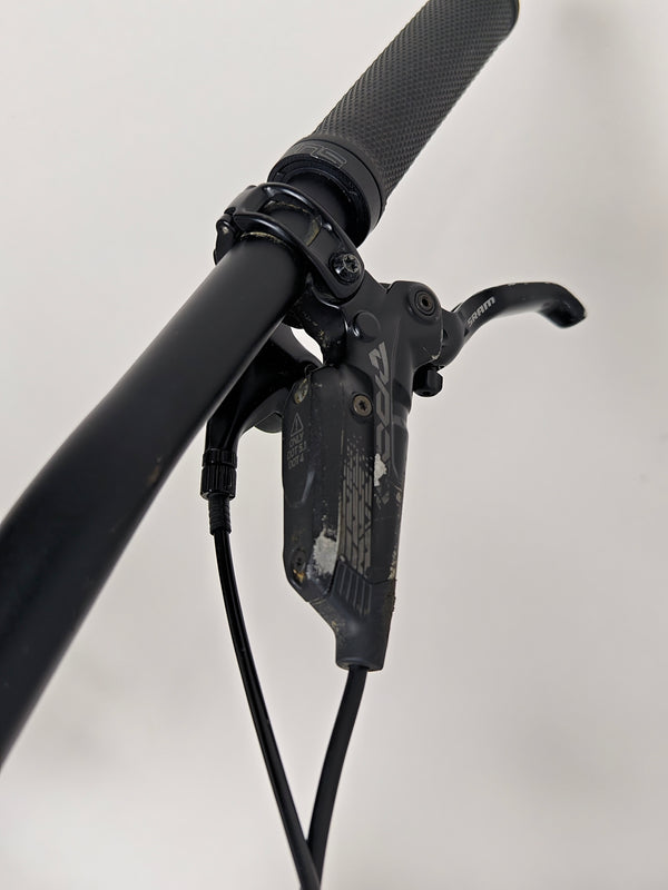 Close view of the cockpit area on the Specialized Status 160, with focused detail on grips and controls.