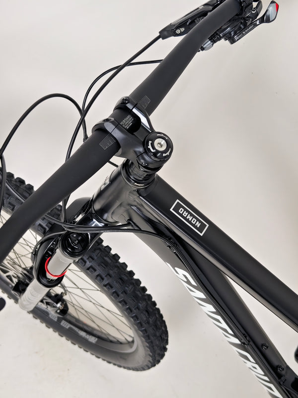 Santa Cruz Nomad Alloy R / SRAM XX1 / HOPE Hubs / E.13 / XL / Top-Spec / Very Good Condition! - Artistic image of the bike in nature, embodying adventure.