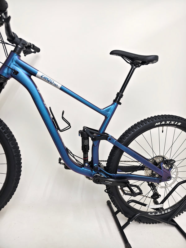 Voodoo CANZO Pro 2026 LARGE Dropper bike beside a mountain trail, showcasing its all-mountain capabilities and Like NEW condition.