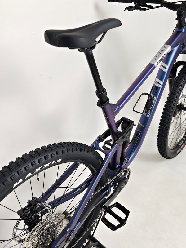 Artistically shot Voodoo CANZO Pro 2026 LARGE Dropper bike amidst natural scenery, displaying its high-quality build and Like NEW condition.