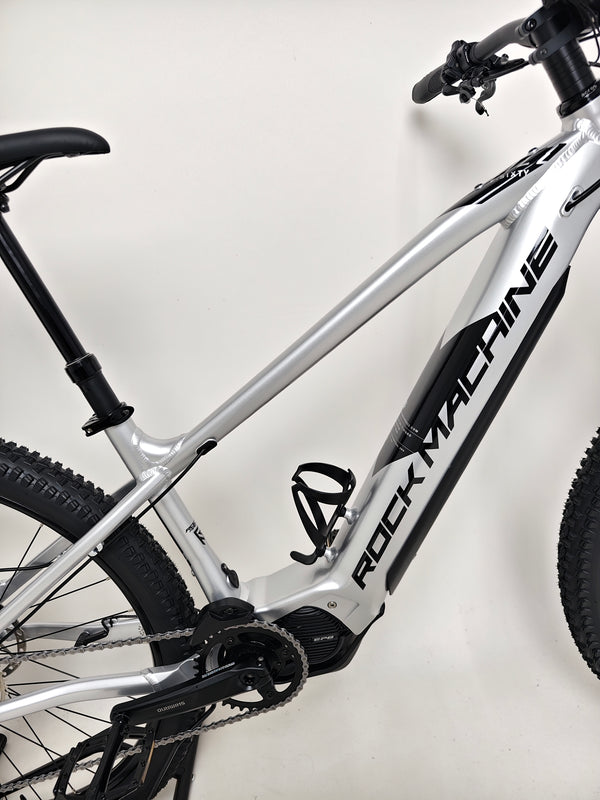 Rock Machine Blizz e60-29 electric mountain bike showcasing the lightweight silver frame and battery.