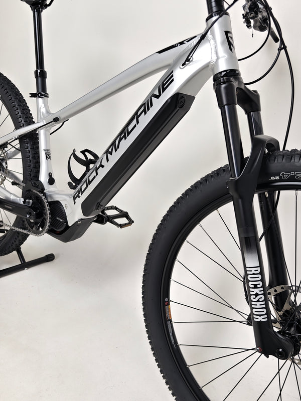 Close-up of Rock Machine Blizz e60-29 electric mountain bike showcasing its frame and suspension features.