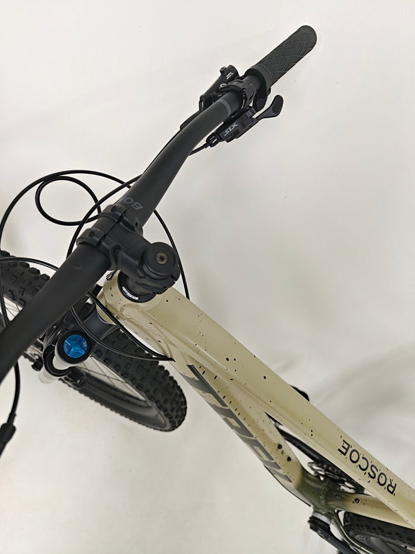 Showcasing Trek ROSCOE 9 2024 Mountain Bike details with trail background, Excellent Condition, Medium size, RRP: £1,850.00, on sale for £1,090.00 at eMado.