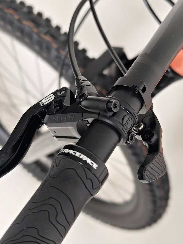 Dynamic shot of the Rocky Mountain Altitude Carbon 70 2022 mountain bike on a rugged terrain, priced at £2,590.00 with free UK delivery.