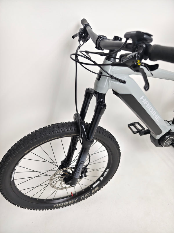Haibike AllTrail 5 27.5 2022 Full Suspension e-Bike showcasing its suspension near a trail. Buy now for only £1,870.00 at eMado!