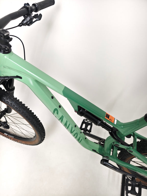 Captured image of the front wheel assembly on the 2023 Canyon Neuron 7 Full Suspension Bike highlighting readiness for ride, Large size, in Very Good Condition.