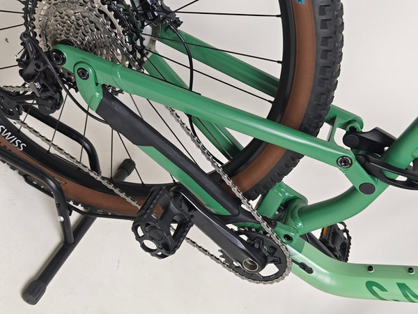 Side profile of the 2023 Canyon Neuron 7 Full Suspension Bike parked, displaying its geometrical design, in Large size and Very Good Condition.