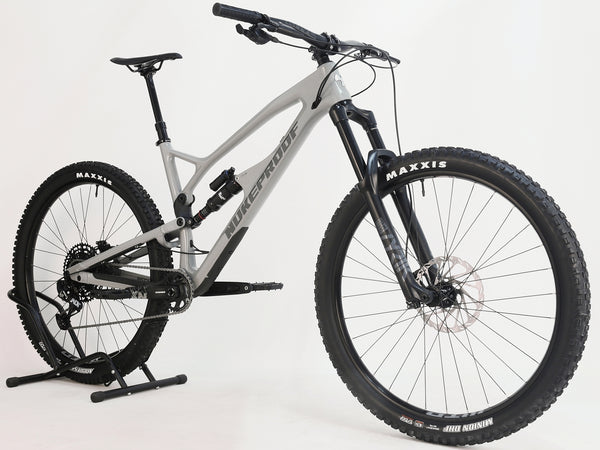 Nukeproof Mega 290 CARBON - Rear view showing the hydraulic SRAM DB8 brakes and wheel setup.