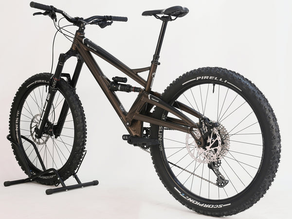 Orange ALPINE 6 Full Suspension Mountain Bike displayed on a trail, ready for adventure.