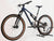 Rocky Mountain Instinct Alloy 10 2023 mountain bike in large size, showcasing its sleek design and brown and blue color scheme, available at eMado Bikes.