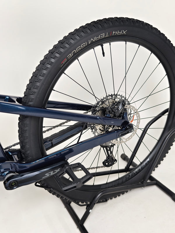 Trek Top Fuel 8 2024 Large Frame Full Suspension Bike at eMado - Portrait of the bike in a vibrant outdoor setting.