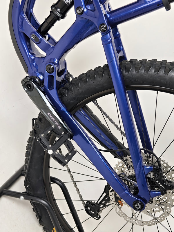 Trek Fuel EX 7 2024 Gen 6 (upgraded), M-L in Very Good Condition - showcasing the bike’s sleek design on a path.