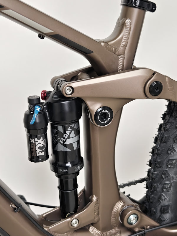 The Transition Smuggler NX 2024 in medium displayed on a rocky path, perfect for adventure seekers.