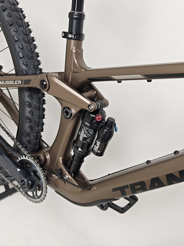 Side profile of the Transition Smuggler NX 2024 in medium in an outdoor setting, highlighting off-road capabilities.