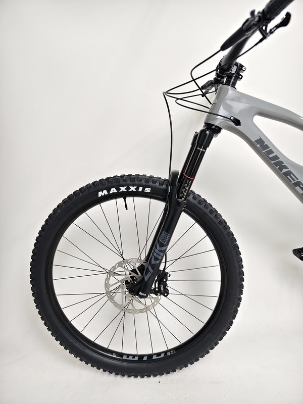 Nukeproof Mega 290 CARBON - Dramatic shot capturing the bike’s sleek structural design.