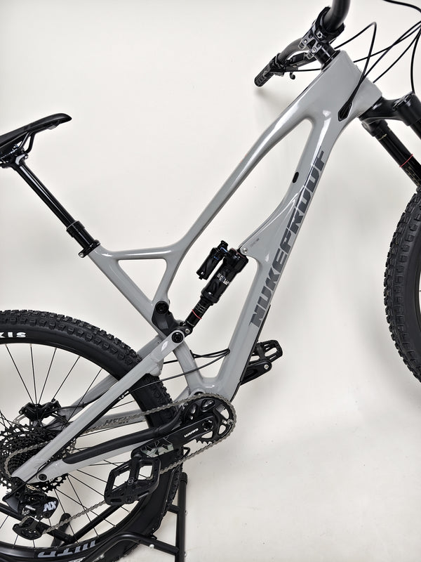 Nukeproof Mega 290 CARBON - Three-quarter angle emphasizing its enduro capability and stylish look.