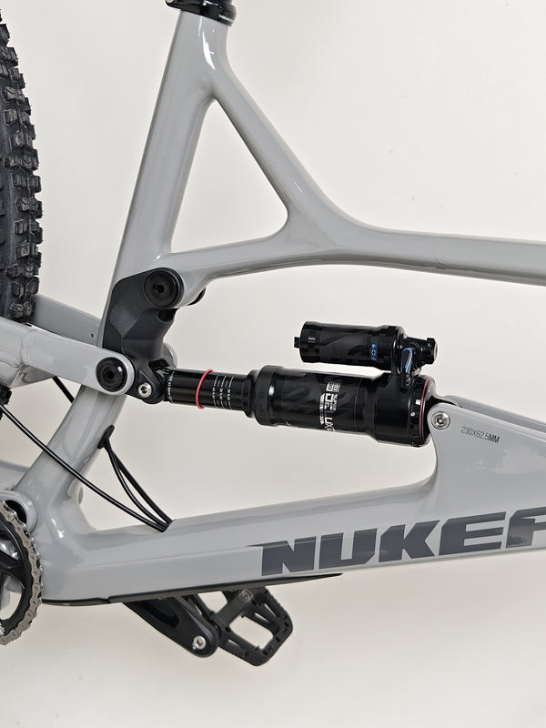 Nukeproof Mega 290 CARBON - Side view showing the bike in a static display.