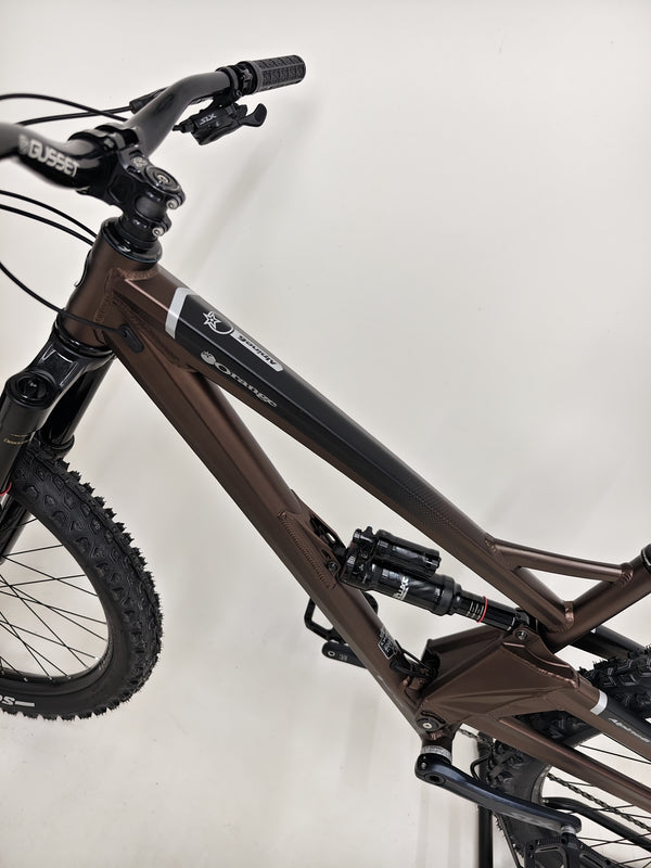 Orange ALPINE 6 Full Suspension Mountain Bike on display, showcasing craftsmanship and quality.