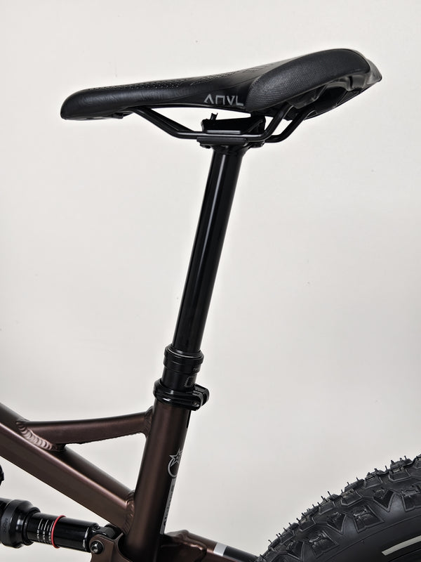 Ornate display of the Orange ALPINE 6 mountain bike at an outdoor event or expo.