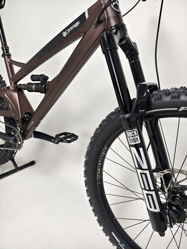 The Orange ALPINE 6 Full Suspension Mountain Bike featuring sleek design and performance-oriented components.