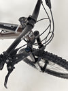 Close view of the gears and shifting mechanism on the Orange ALPINE 6 mountain bike.