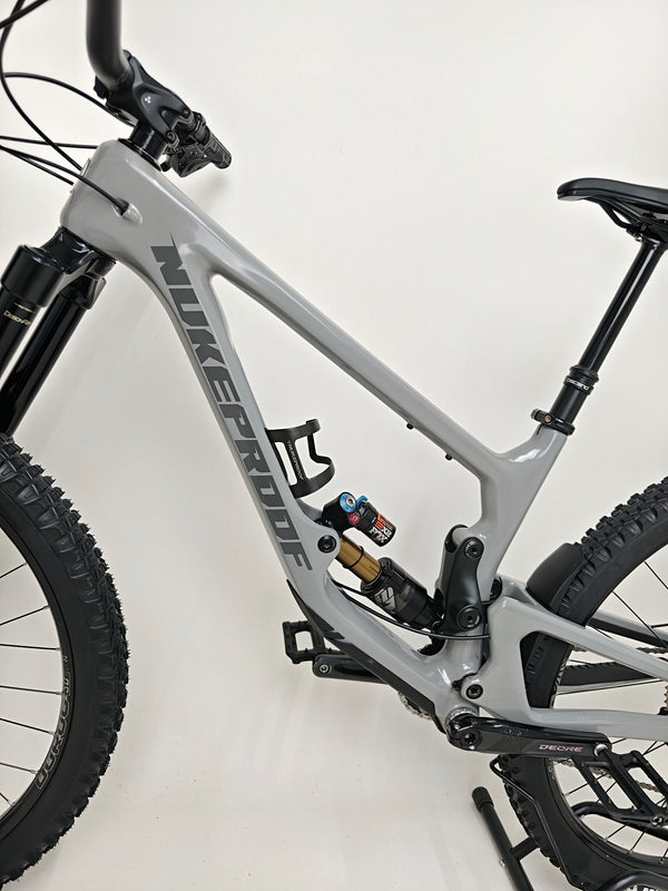Nukeproof Giga 290 Comp Carbon 2022 bike with detailed view of the brakes and wheels.
