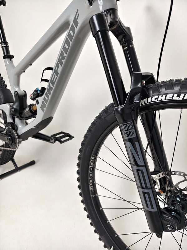 Full frontal view of the Nukeproof Giga 290 Comp Carbon 2022 mountain bike under natural light.