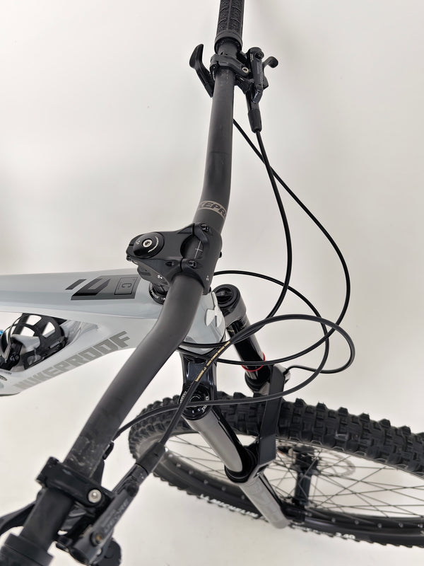 Nukeproof Giga 290 Comp Carbon 2022 bike on a rocky trail illustrating its capability.