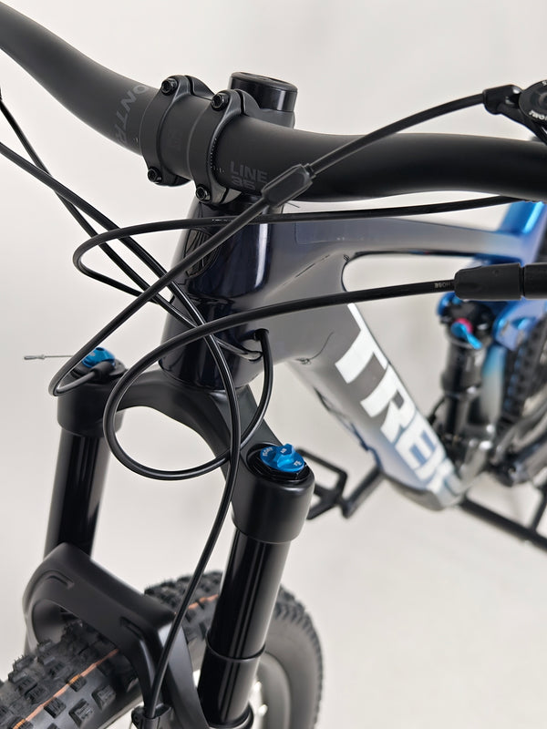 Trek Top Fuel 9.7 2022 CARBON bike's wheels and tires capturing dirt trail use.