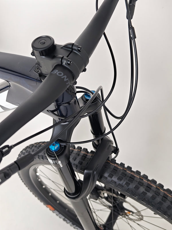 Trek Top Fuel 9.7 2022 CARBON mountain bike parked off-road ready for adventure.