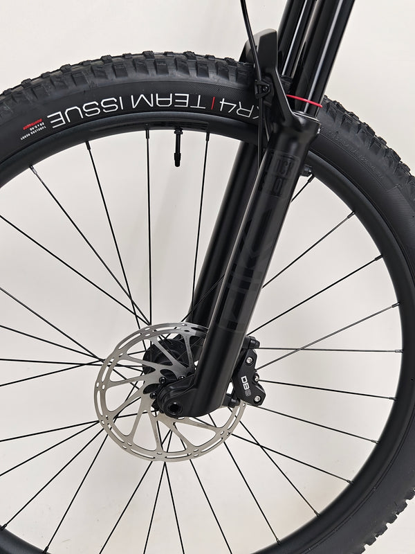 Trek Top Fuel 8 GX AXS 2024 captured in natural light highlighting its sleek matte black finish.