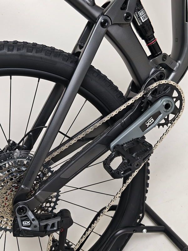 Trek Top Fuel 8 GX AXS 2024 model showcased in a rugged terrain setting suitable for mountain biking.