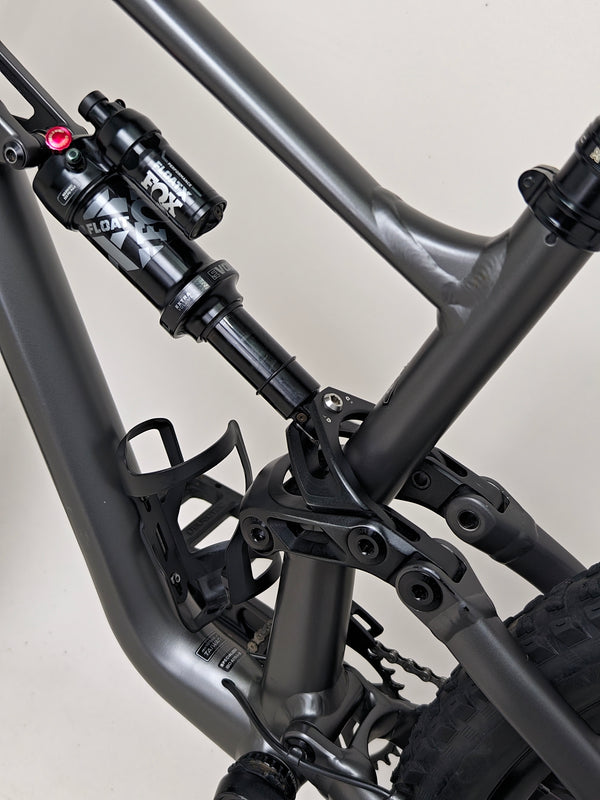 A celebratory image of the Specialized Status 160 after a successful ride on mountain trails.