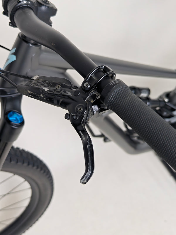 Detail view of the suspension settings on the Specialized Status 160, highlighting its adjustable features.