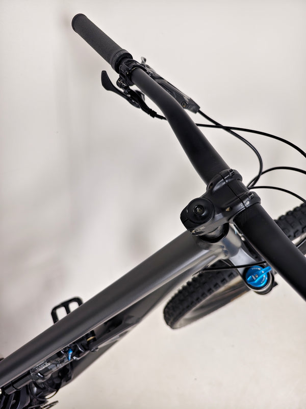 Close-up of the bike frame and suspension linkage on the Specialized Status 160, emphasizing engineering quality.