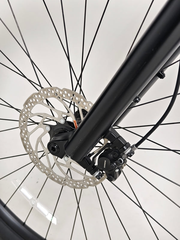 Snapshot of the Specialized Turbo Tero 3.0 near a lake, depicting its suitability for adventure and leisure.