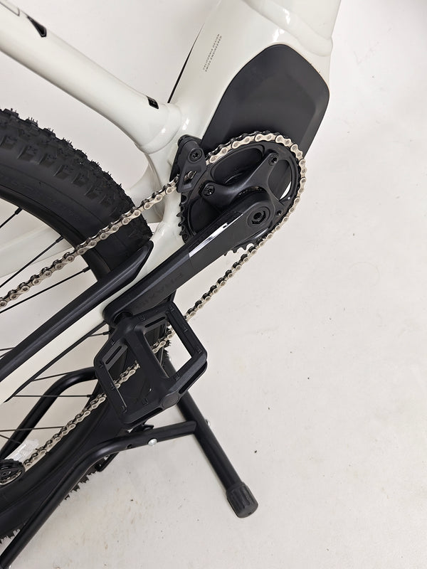 Dynamic shot of the Specialized Turbo Tero 3.0 surfacing through dense woodland terrain.