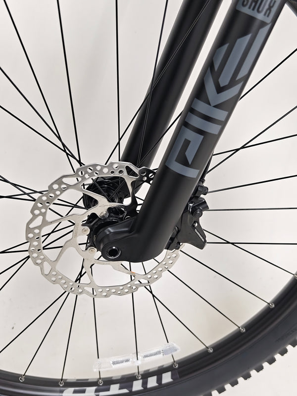 Voodoo CANZO Pro 2026 LARGE Dropper bike captured on rocky terrain, exemplifying its durability and performance in Like NEW state.