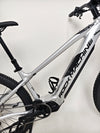 Rock Machine Blizz e60-29 electric mountain bike showcasing the lightweight silver frame and battery.