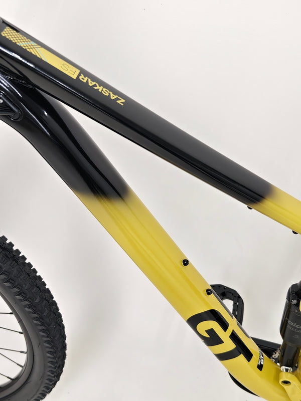 Rear view of the GT Zaskar FS Sport 2024 on a trail emphasizing functionality in wilderness.