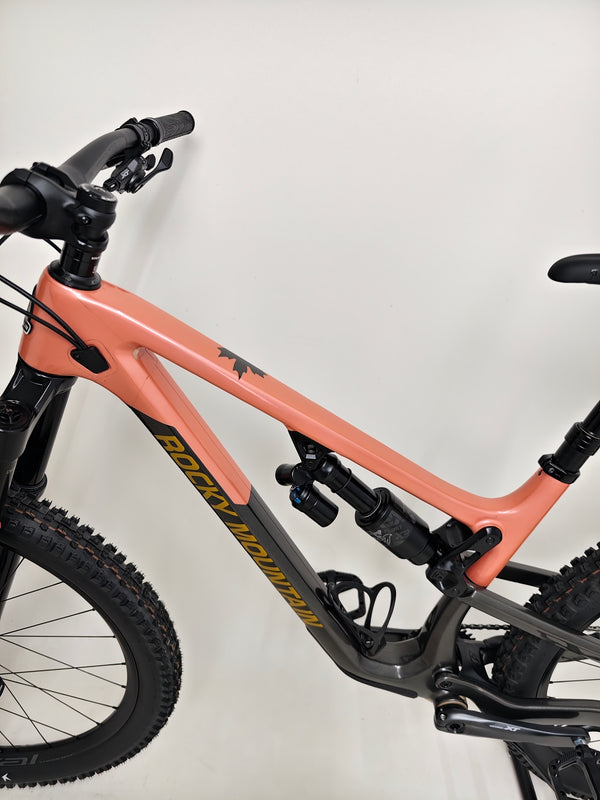 The Rocky Mountain Altitude Carbon 70 2022 mountain bike on a trail, showcasing its great performance, available for £2,590.00 with free UK delivery.