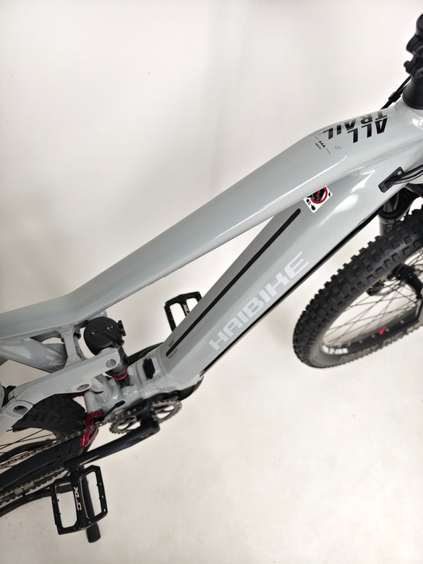 Close-up on the Haibike AllTrail 5 27.5 2022 Full Suspension e-Bike showing the quick-release front wheel mechanism. Available for just £1,870.00 at eMado!