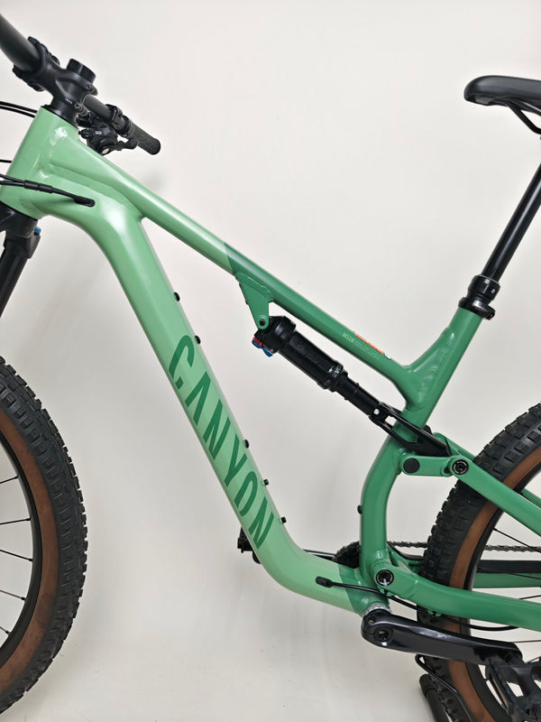 Brake detail on the 2023 Canyon Neuron 7 Full Suspension Bike, showcasing Shimano SLX M7120 hydraulic disc brakes, in Very Good Condition.