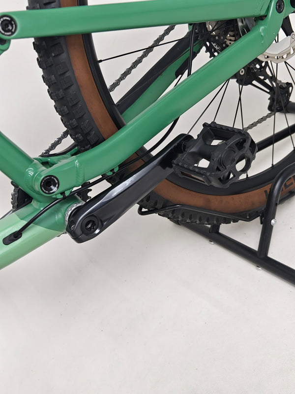 An open field view featuring the 2023 Canyon Neuron 7 Full Suspension Bike, displaying features that contribute to performance, Large size, in Very Good Condition.