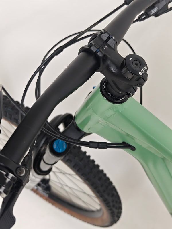 The 2023 Canyon Neuron 7 Full Suspension Bike displayed in a natural setting, focusing on the frame details, in Large size and Very Good Condition.