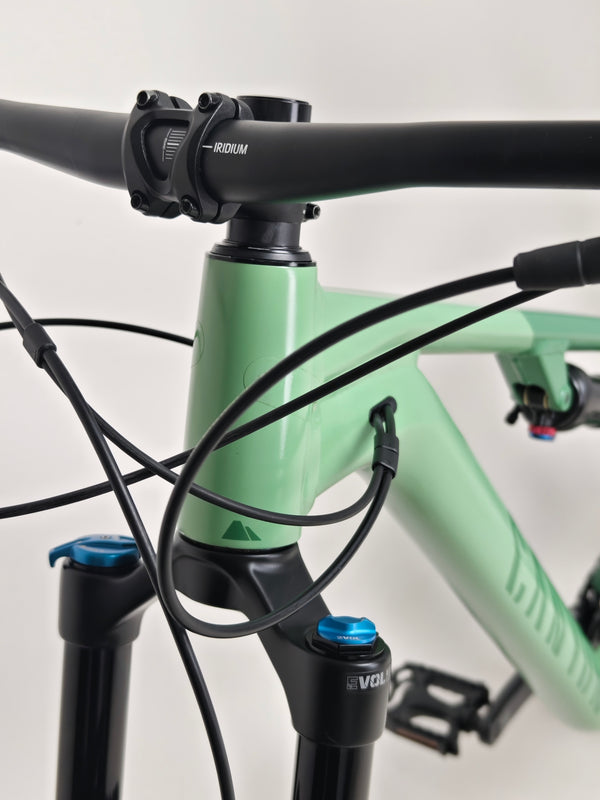 The 2023 Canyon Neuron 7 Full Suspension Bike in motion, showing off its smooth design and mechanics, in Large size and Very Good Condition.