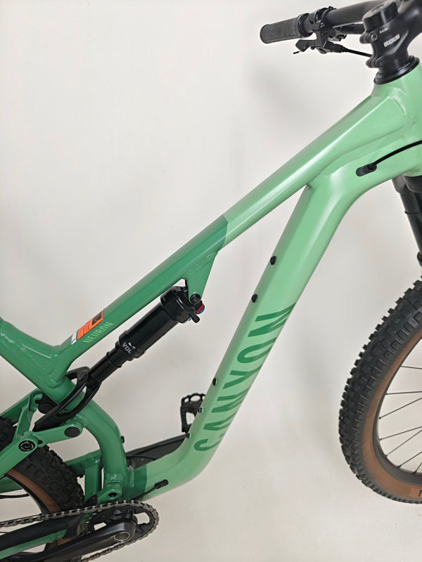 Lifestyle shot of the 2023 Canyon Neuron 7 Full Suspension Bike in use by a rider on trail, displaying Large size, in Very Good Condition.