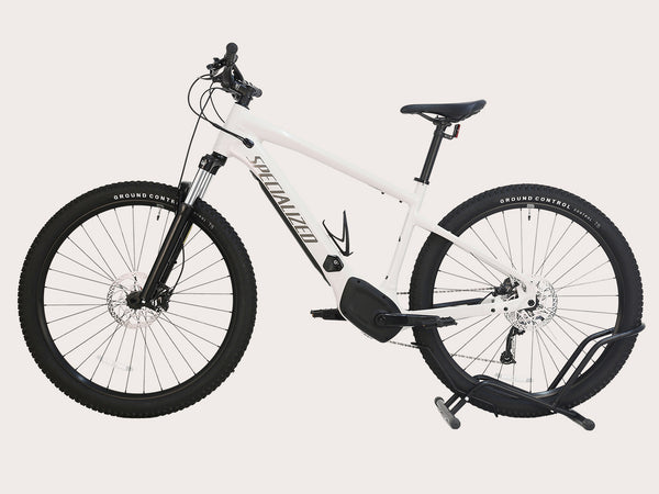 Side angle of the Specialized Turbo Tero 3.0 Electric MTB 2022 in white color, highlighting the integrated battery and modern design.
